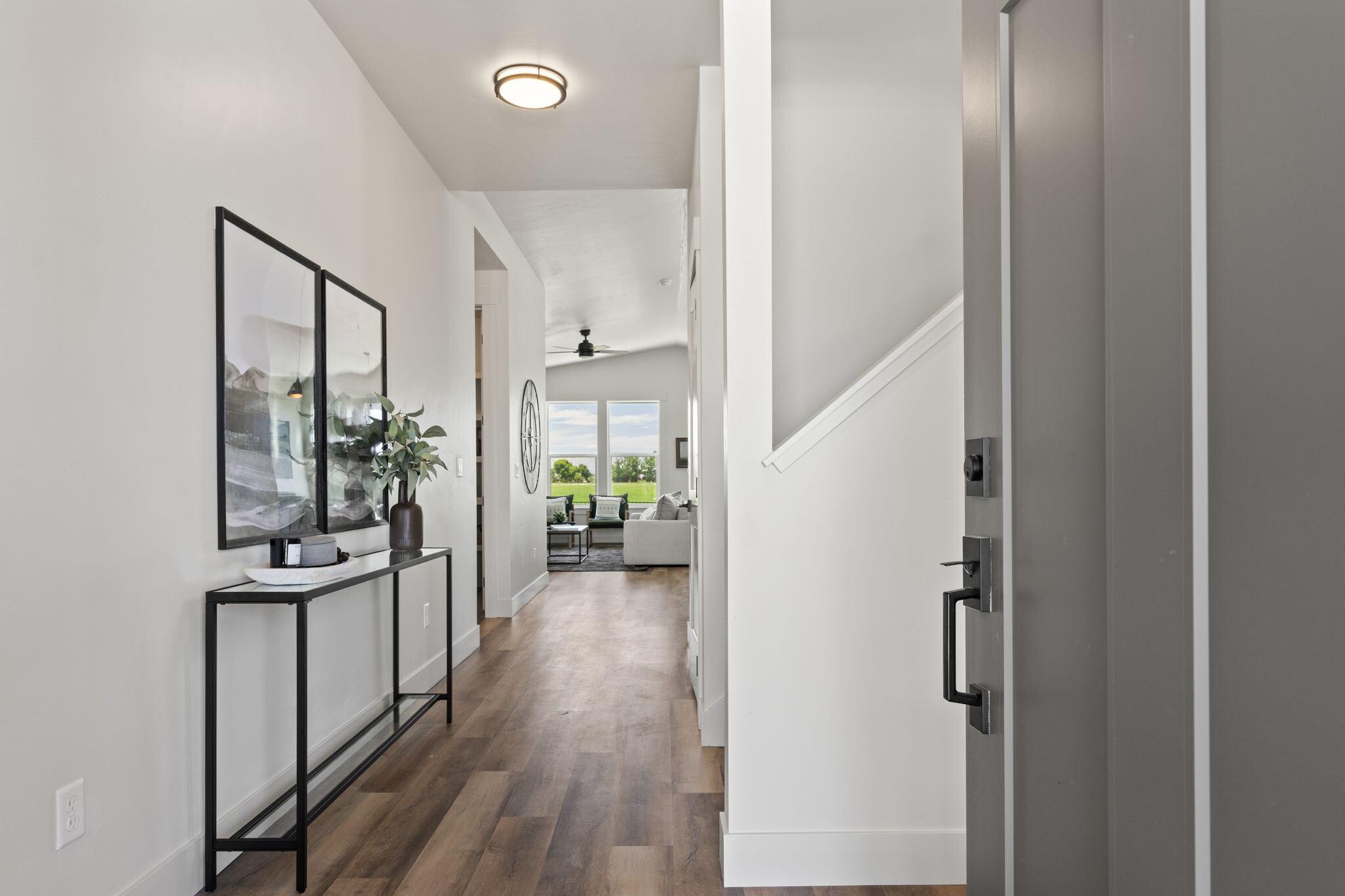 Entry hall of the Grand Harvest Avenue home, looking through to the living room past the staircase