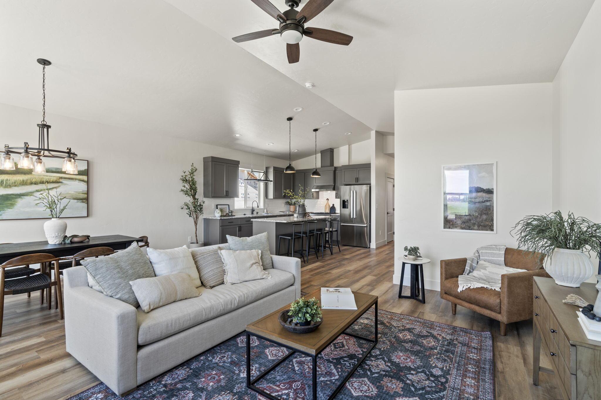 Vaulted open-plan great room with the dining area and kitchen beyond, in the Grand Harvest Avenue home