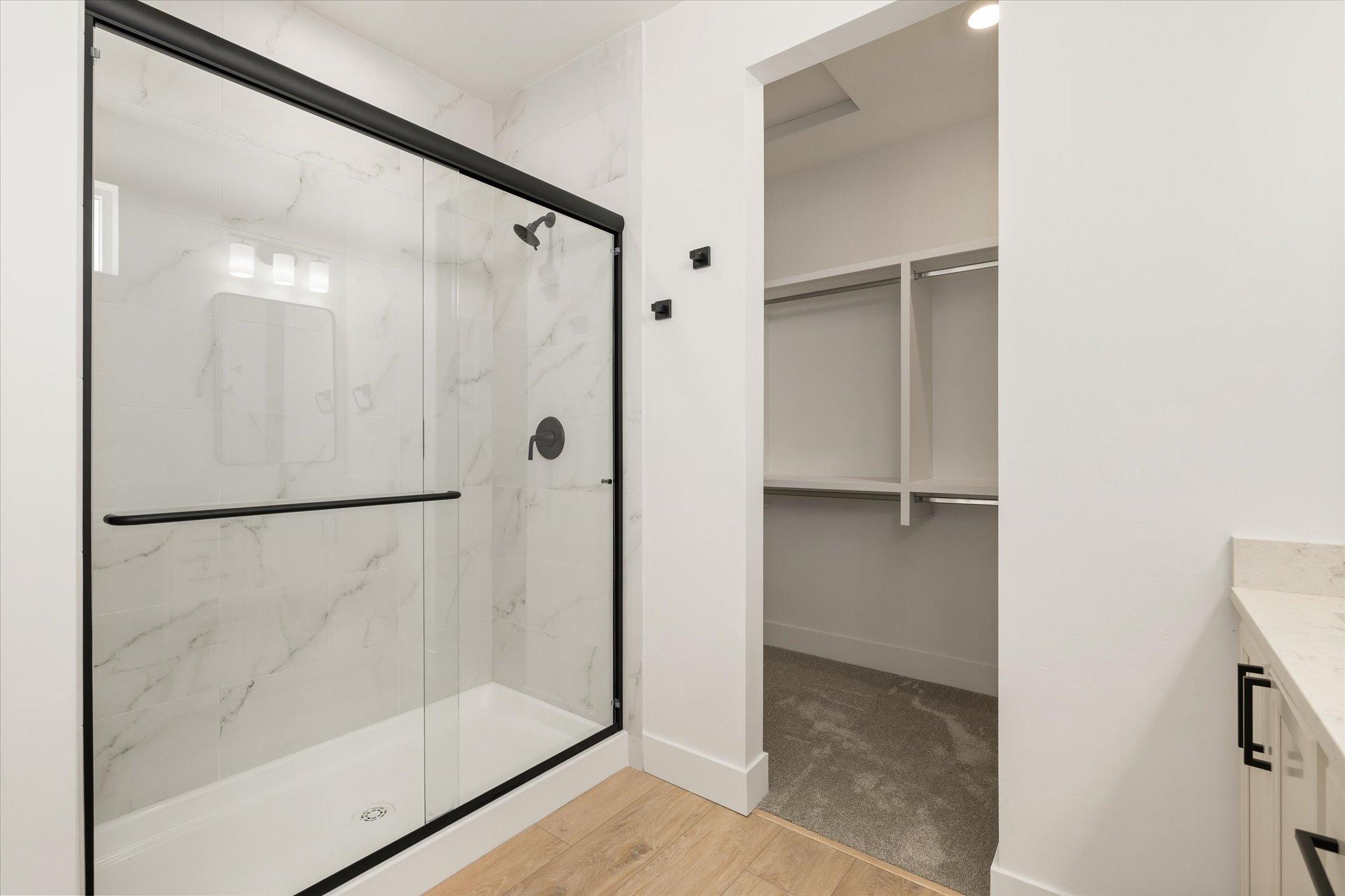 Walk-in shower in the primary bathroom, next to the walk-in closet