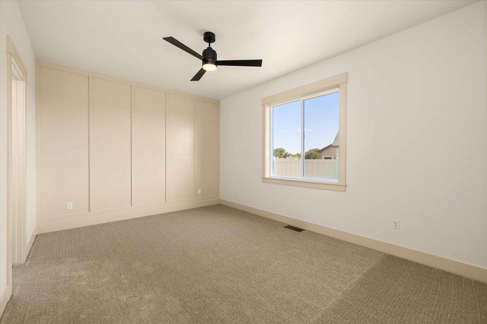 Carpeted bedroom with a ceiling fan at 601 Grand Harvest Avenue