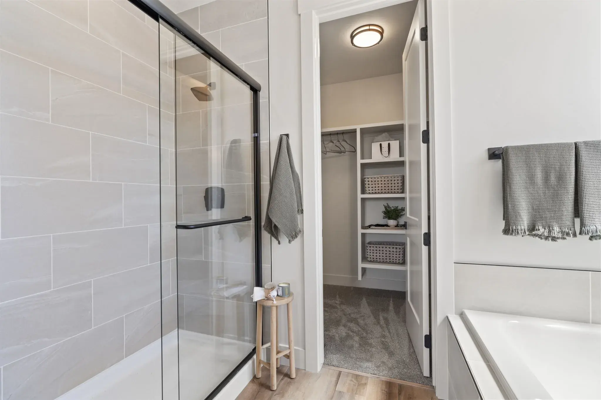 The tiled walk-in shower and soaking tub in the primary bathroom at Harvest Creek Vaulted Home