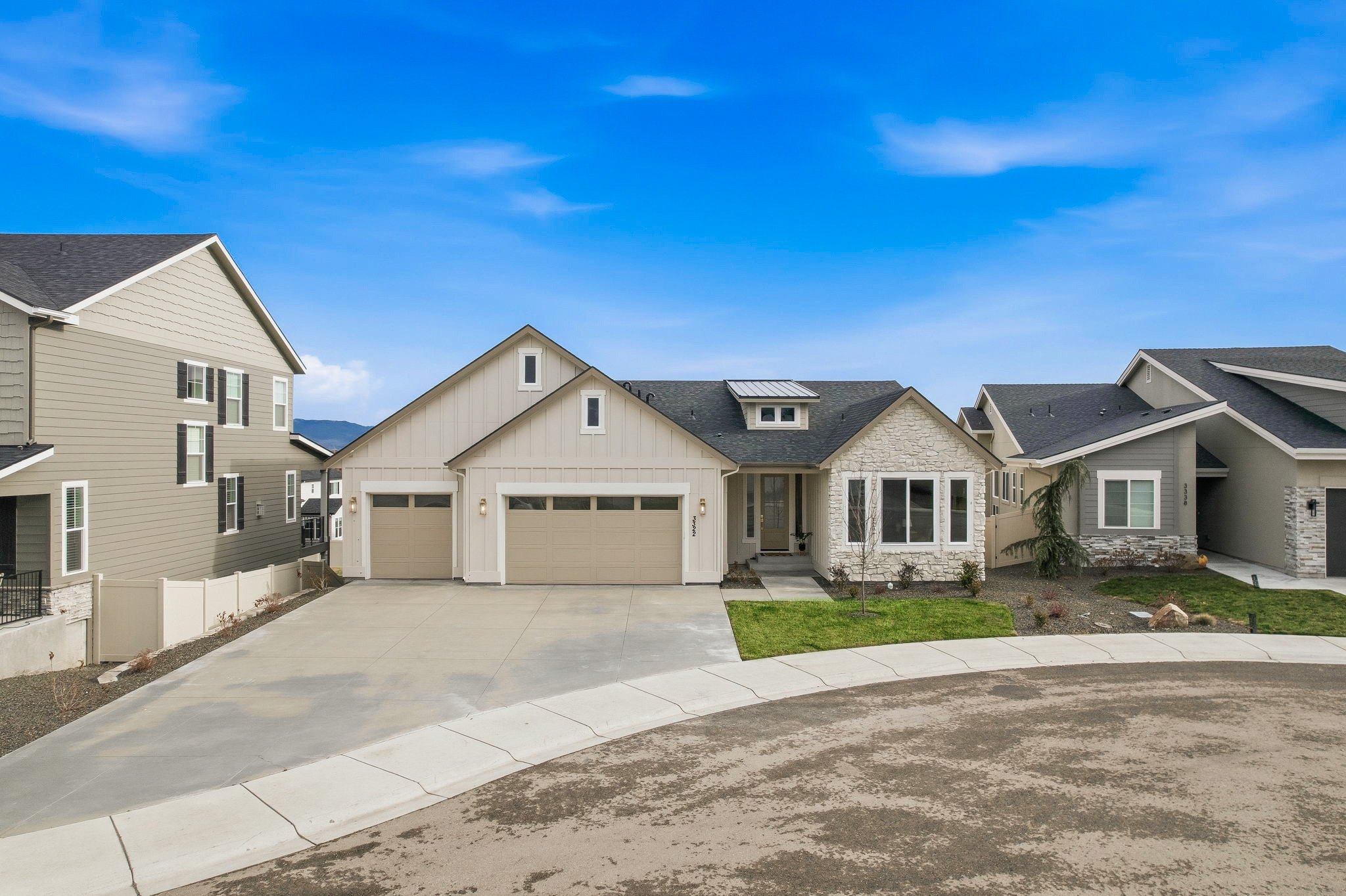 The front of White Oak & Timber in Meridian: board and batten siding, stone accents, and a three car garage